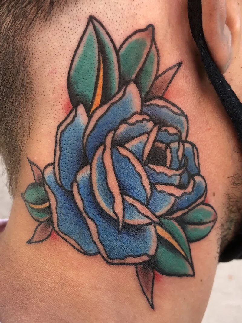 Traditional rose tattoo on the side of the neck rendered in cool teal blues instead of the usual red, by Dustin Gormley at Ohana Tattoo, Waikiki, Hawaii.